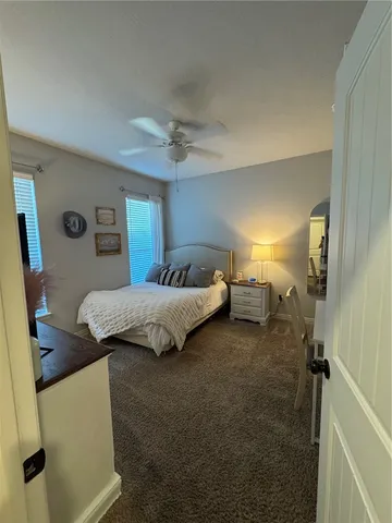 a bedroom with a bed and a mirror