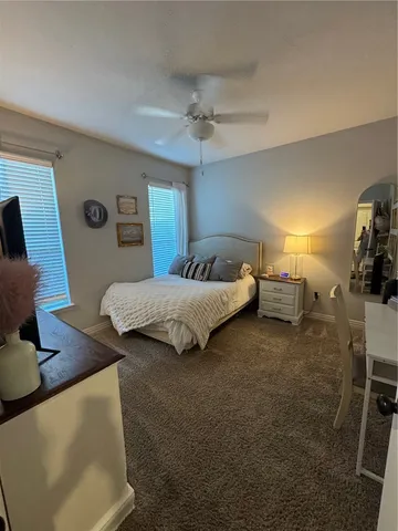 a bedroom with bed and window