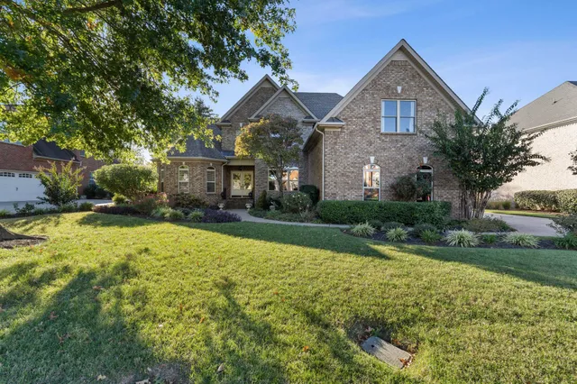 a front view of a house with a yard