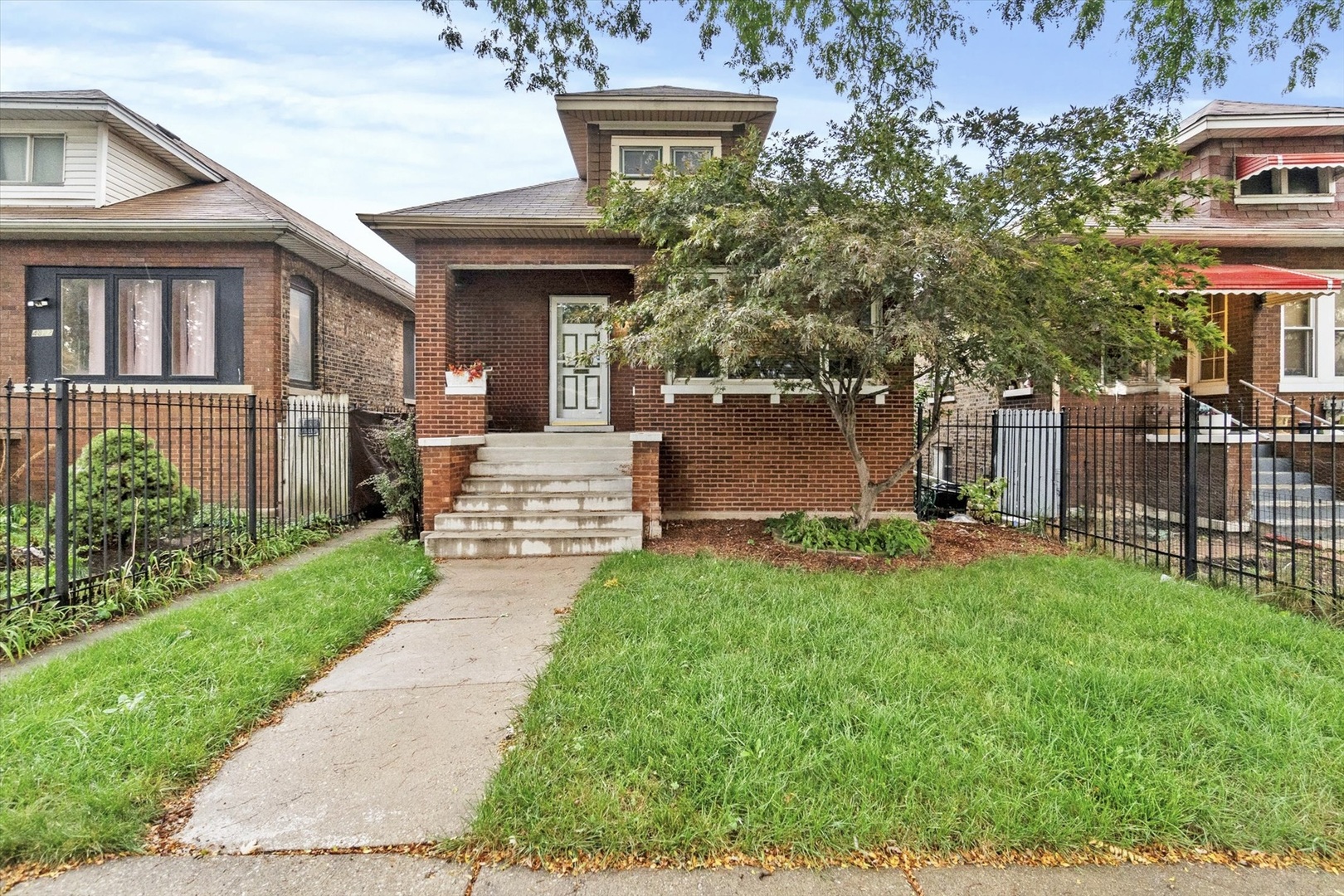4820 West Haddon Avenue Chicago, IL 60651 - Photo 1 of 27 a front view of a house with a yard