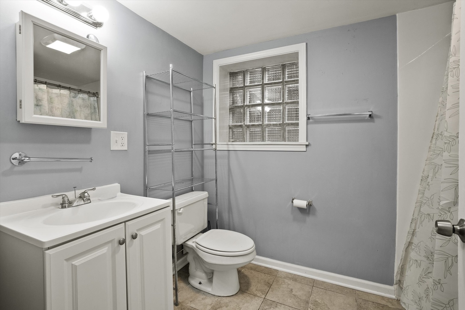 4820 West Haddon Avenue Chicago, IL 60651 - Photo 15 of 27 a bathroom with a sink a toilet and shower