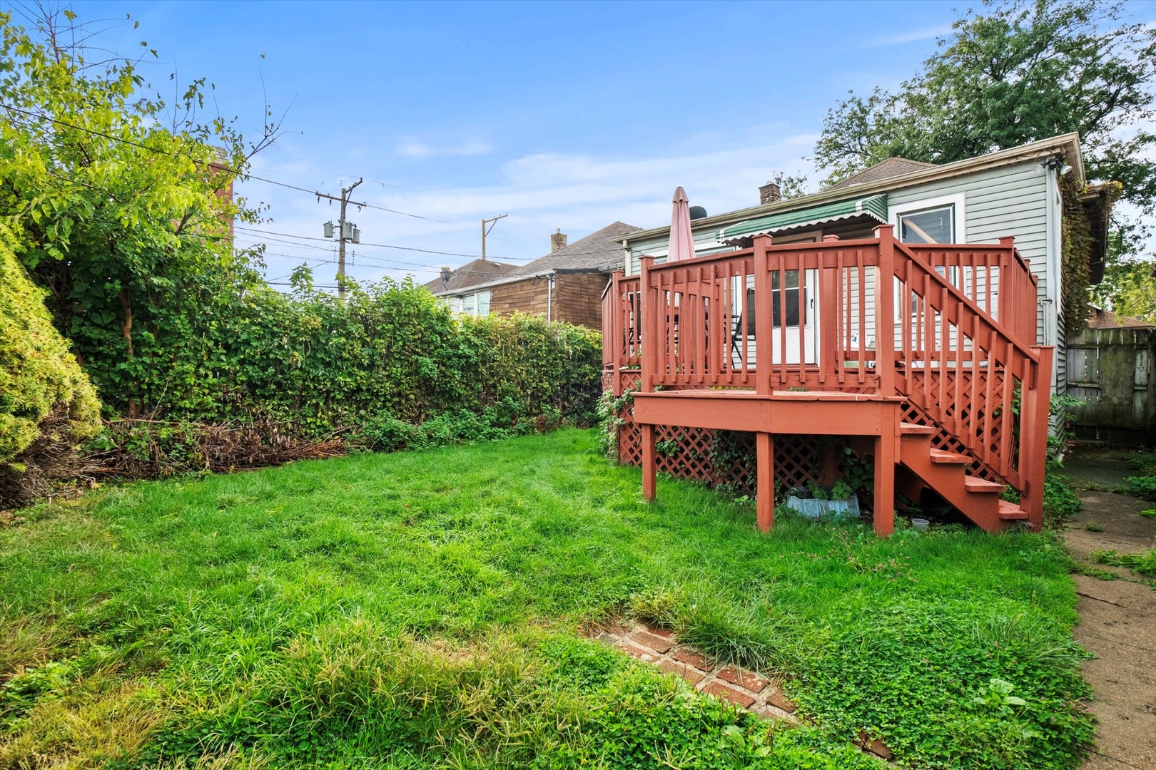 4820 West Haddon Avenue Chicago, IL 60651 - Photo 23 of 27 a view of a house with a yard deck and a garden