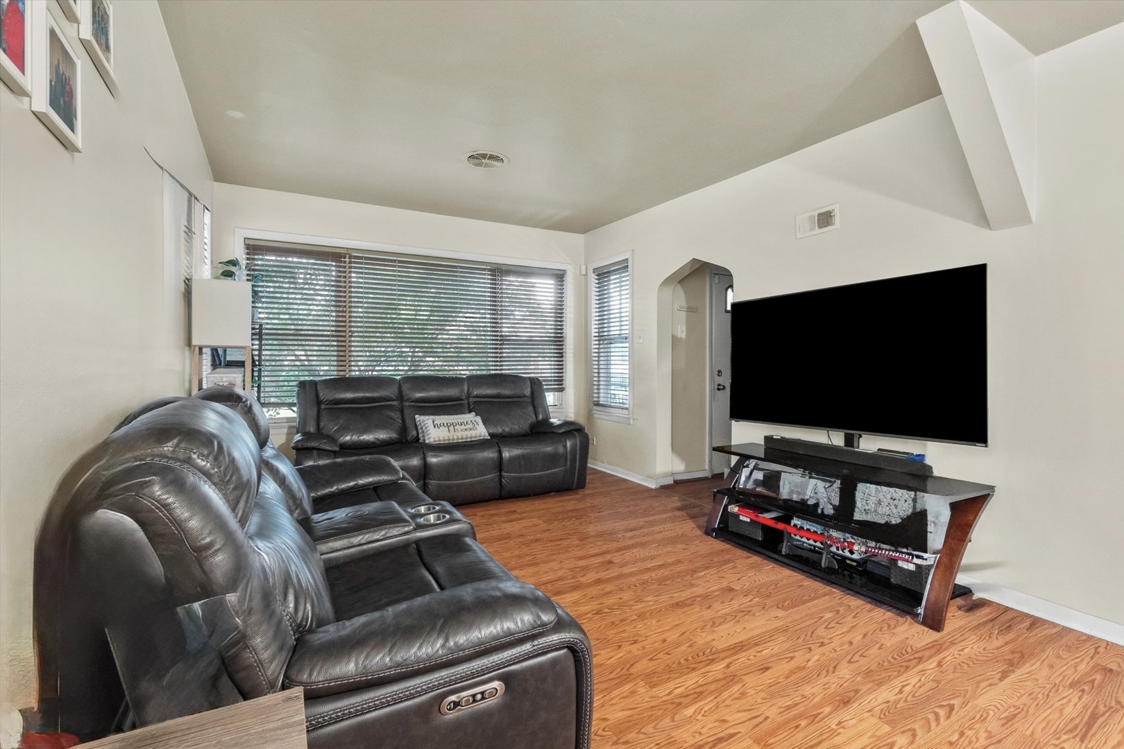 4820 West Haddon Avenue Chicago, IL 60651 - Photo 3 of 27 a living room with furniture and a flat screen tv