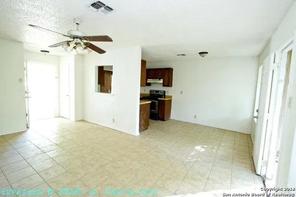 a view of a kitchen with a sink and a refrigerator