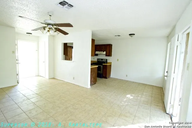 a view of a kitchen with a sink and a refrigerator