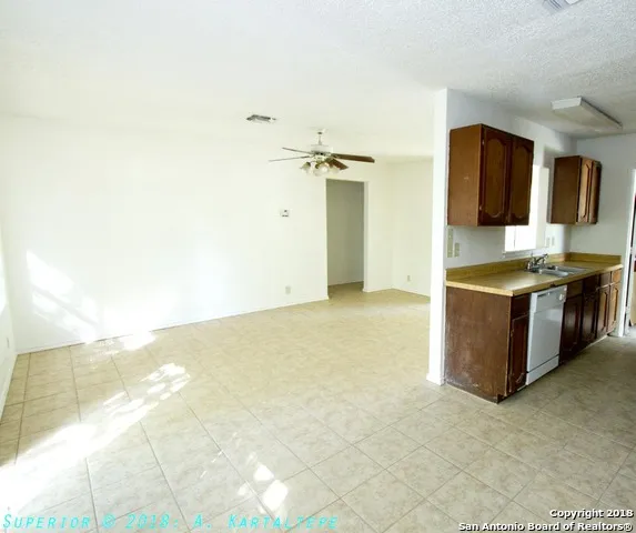 a view of a kitchen with stainless steel appliances a sink and cabinets