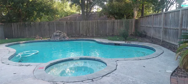a view of a swimming pool with a backyard
