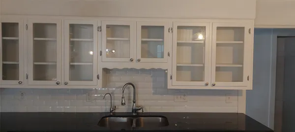 a bathroom with a sink and cabinets