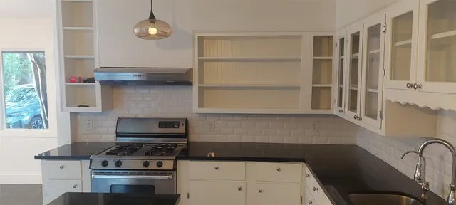 a kitchen with a stove and a microwave