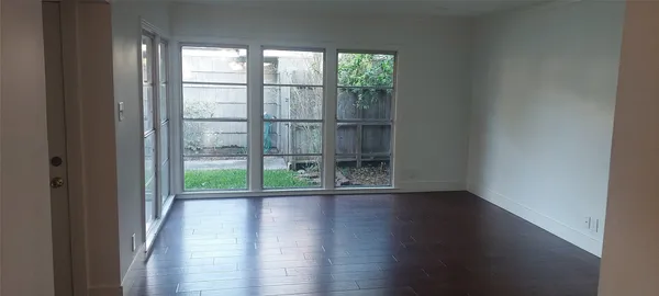 a view of wooden floor and windows in a room