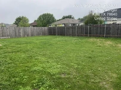 a view of a backyard with a fence