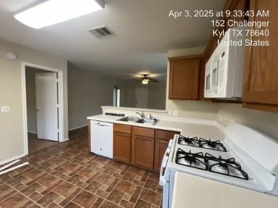 a kitchen with a sink stove and cabinets