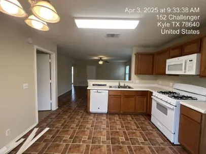 a kitchen with a stove a sink and a refrigerator