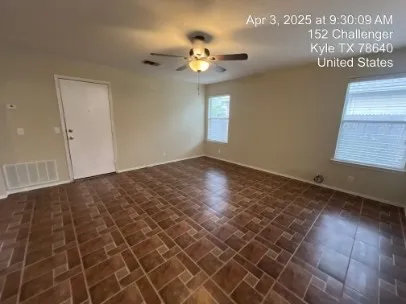 a view of a livingroom with a ceiling fan and window