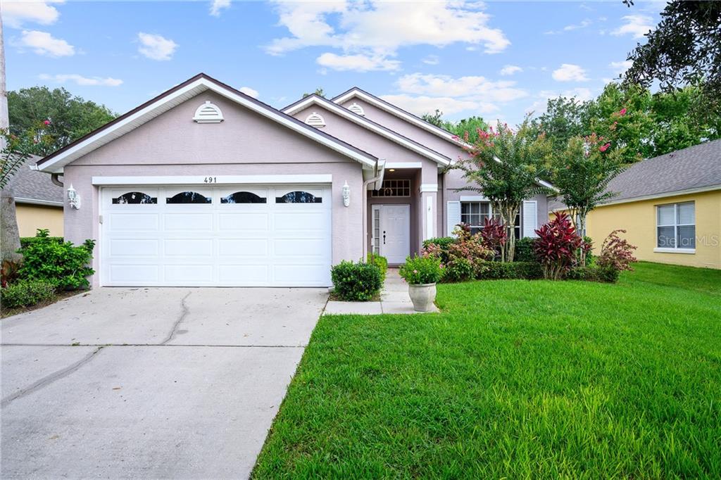 491 Mickleton Loop Ocoee, FL 34761 - Photo 1 of 1 Mature landscaping, lush green lawn and an ample two car garage are ready for their new family.