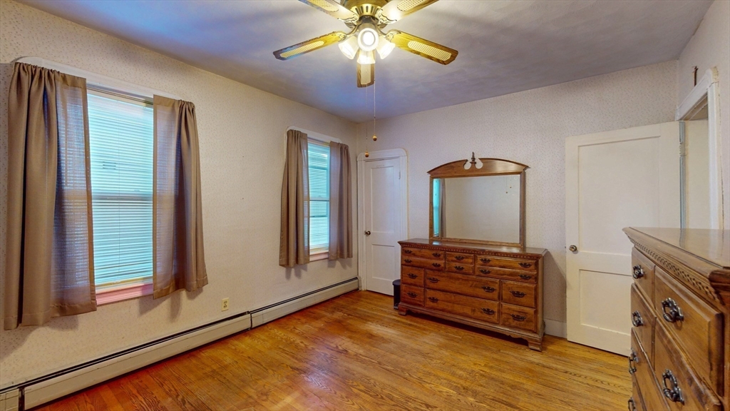99 Lyons Street Springfield, MA 01151 - Photo 19 of 41 a view of room with wooden floor and ceiling fan