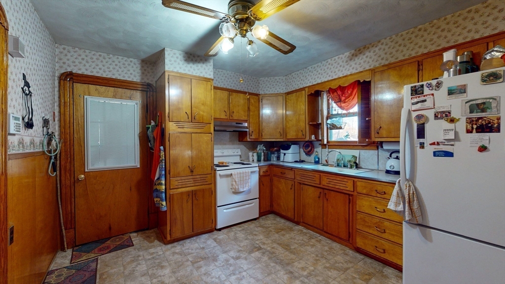 99 Lyons Street Springfield, MA 01151 - Photo 23 of 41 a kitchen with stainless steel appliances granite countertop a refrigerator and a sink