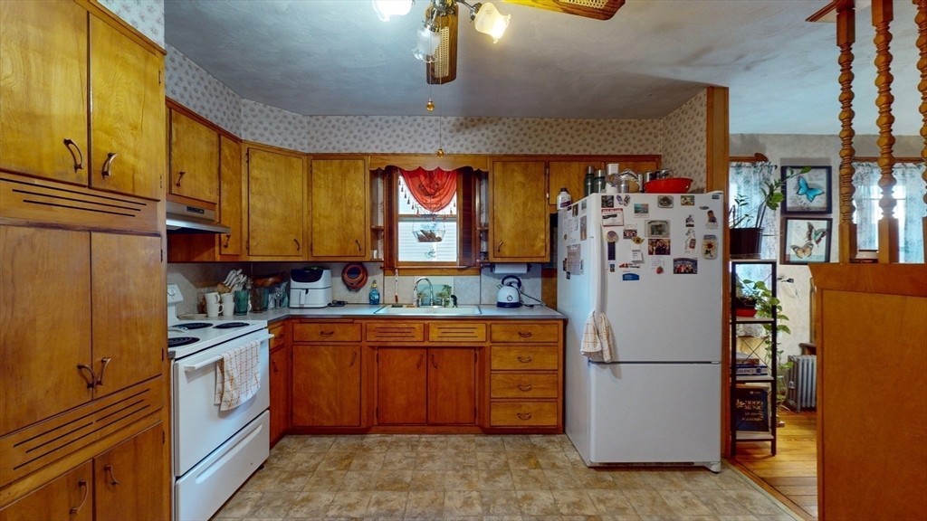 99 Lyons Street Springfield, MA 01151 - Photo 25 of 41 a kitchen with stainless steel appliances granite countertop a refrigerator a stove and a sink with cabinets
