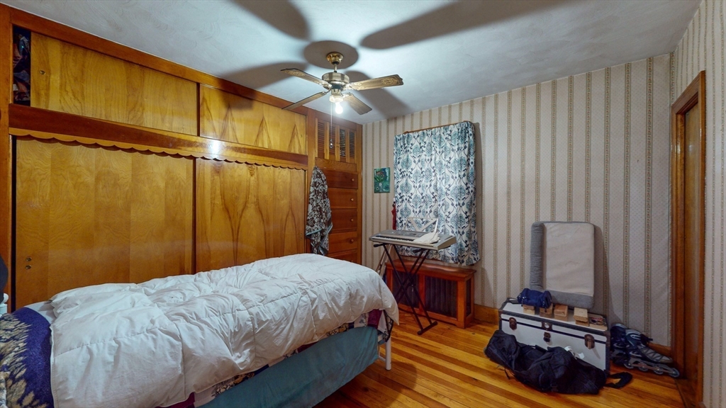 99 Lyons Street Springfield, MA 01151 - Photo 28 of 41 a bedroom with a bed and a mirror