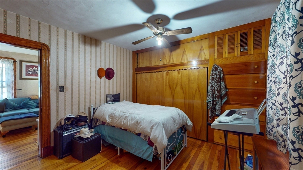 99 Lyons Street Springfield, MA 01151 - Photo 29 of 41 a bedroom with a bed and a mirror