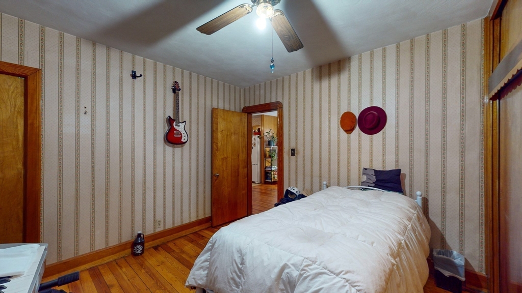 99 Lyons Street Springfield, MA 01151 - Photo 30 of 41 a bedroom with a bed and a chandelier