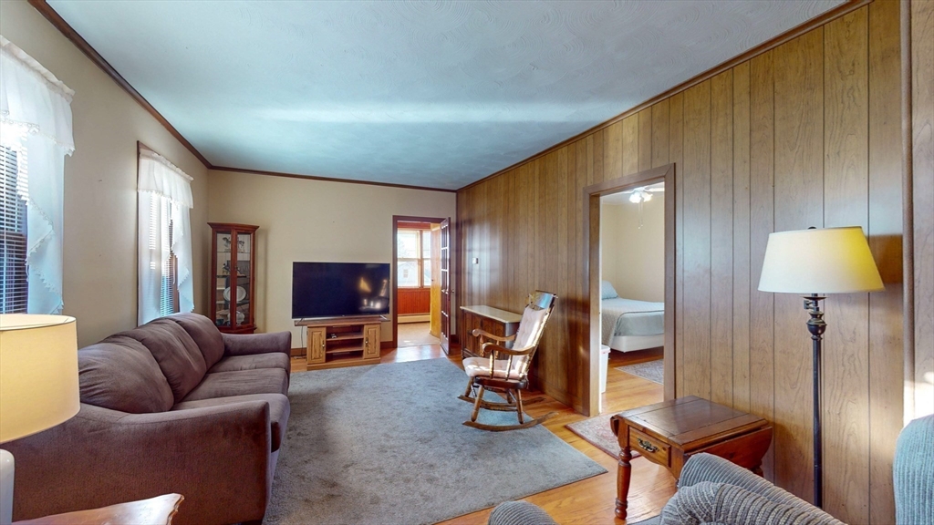 99 Lyons Street Springfield, MA 01151 - Photo 7 of 41 a living room with furniture and a flat screen tv