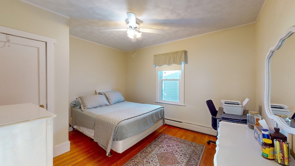 99 Lyons Street Springfield, MA 01151 - Photo 8 of 41 a bedroom with a bed and a chandelier