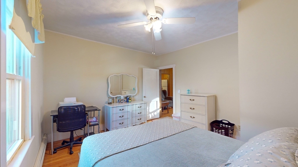 99 Lyons Street Springfield, MA 01151 - Photo 10 of 41 a bedroom with a bed and a chandelier