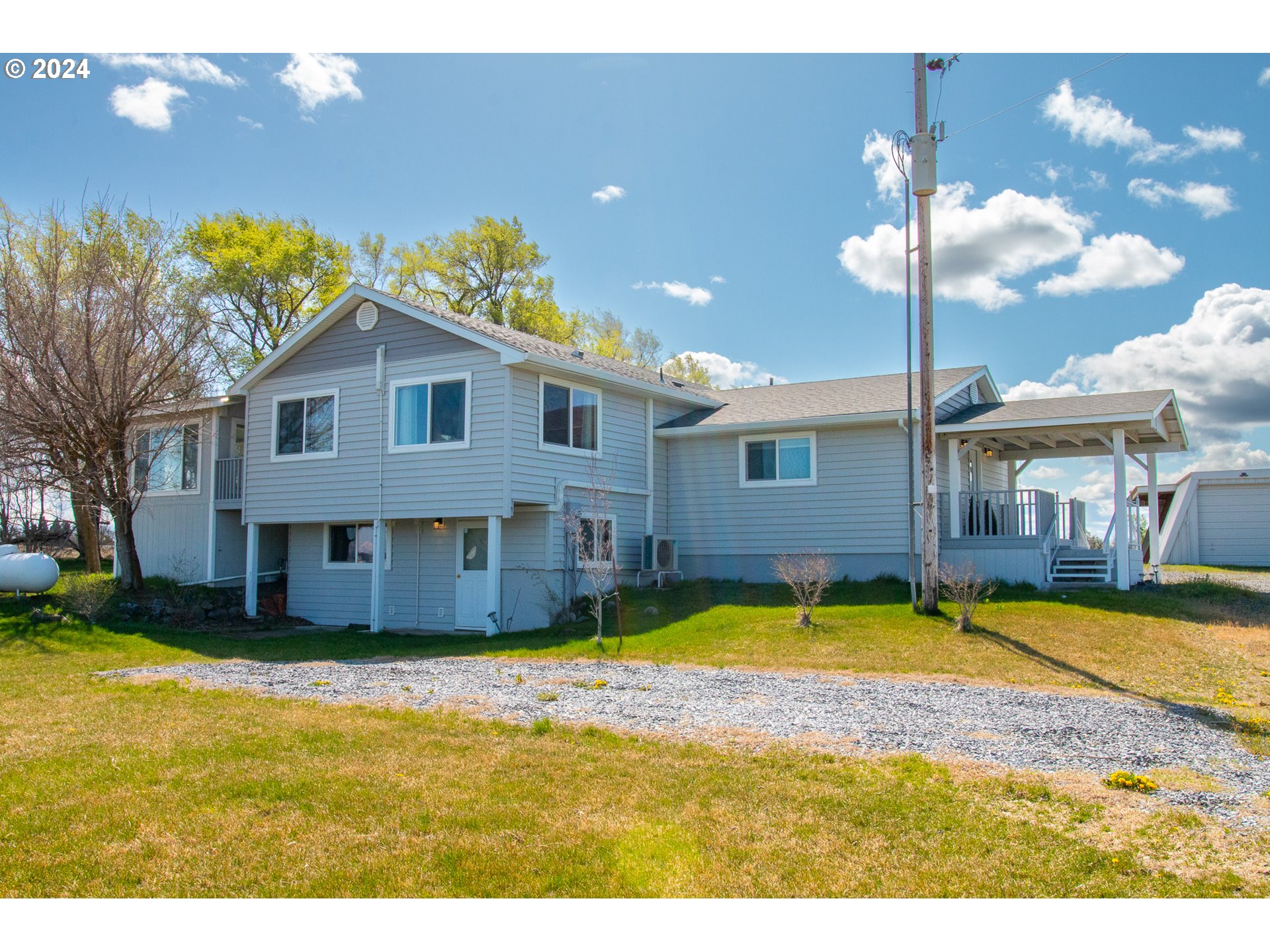 32256 West Walls Road Hermiston, OR 97838 - Photo 1 of 41 a view of a house with swimming pool and a yard