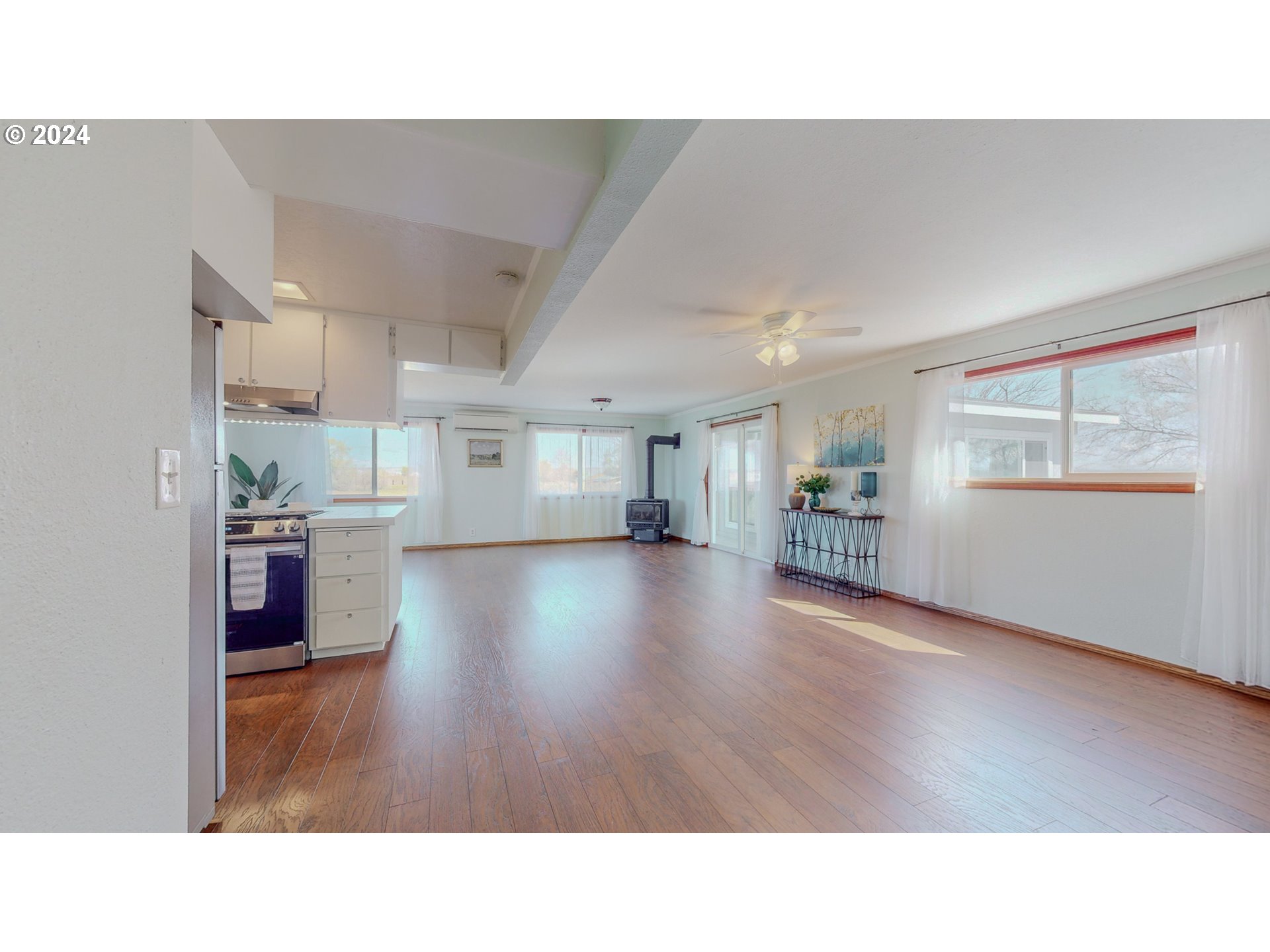 32256 West Walls Road Hermiston, OR 97838 - Photo 12 of 41 a open hall with wooden floor and kitchen