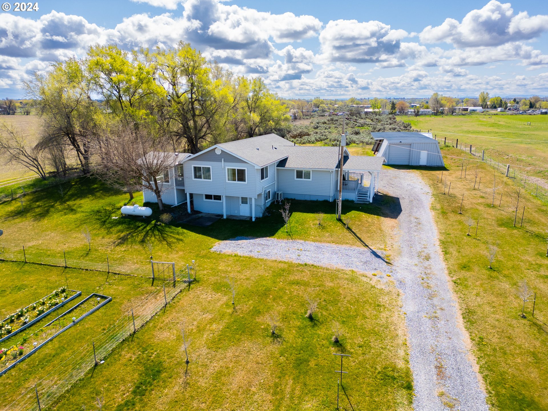 32256 West Walls Road Hermiston, OR 97838 - Photo 29 of 41 a aerial view of a house with swimming pool and large trees