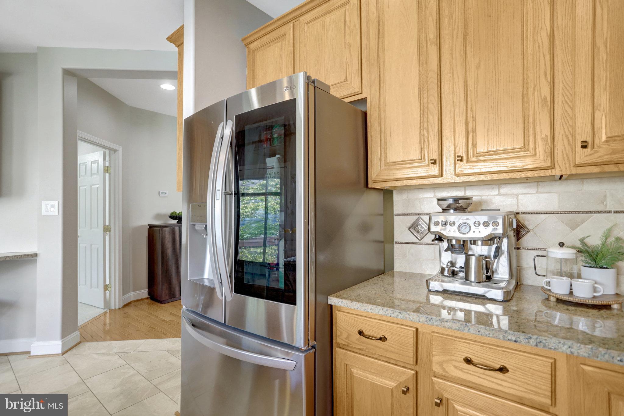 8552 Bauer Circle Springfield, VA 22152 - Photo 16 of 64 a kitchen with stainless steel appliances granite countertop a refrigerator and a sink