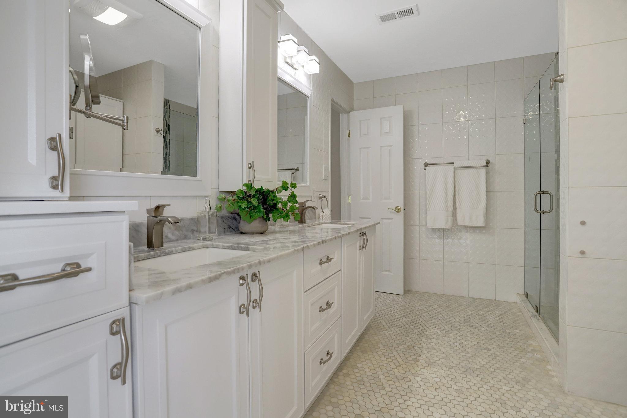 8552 Bauer Circle Springfield, VA 22152 - Photo 35 of 64 a spacious bathroom with a granite countertop sink and a mirror