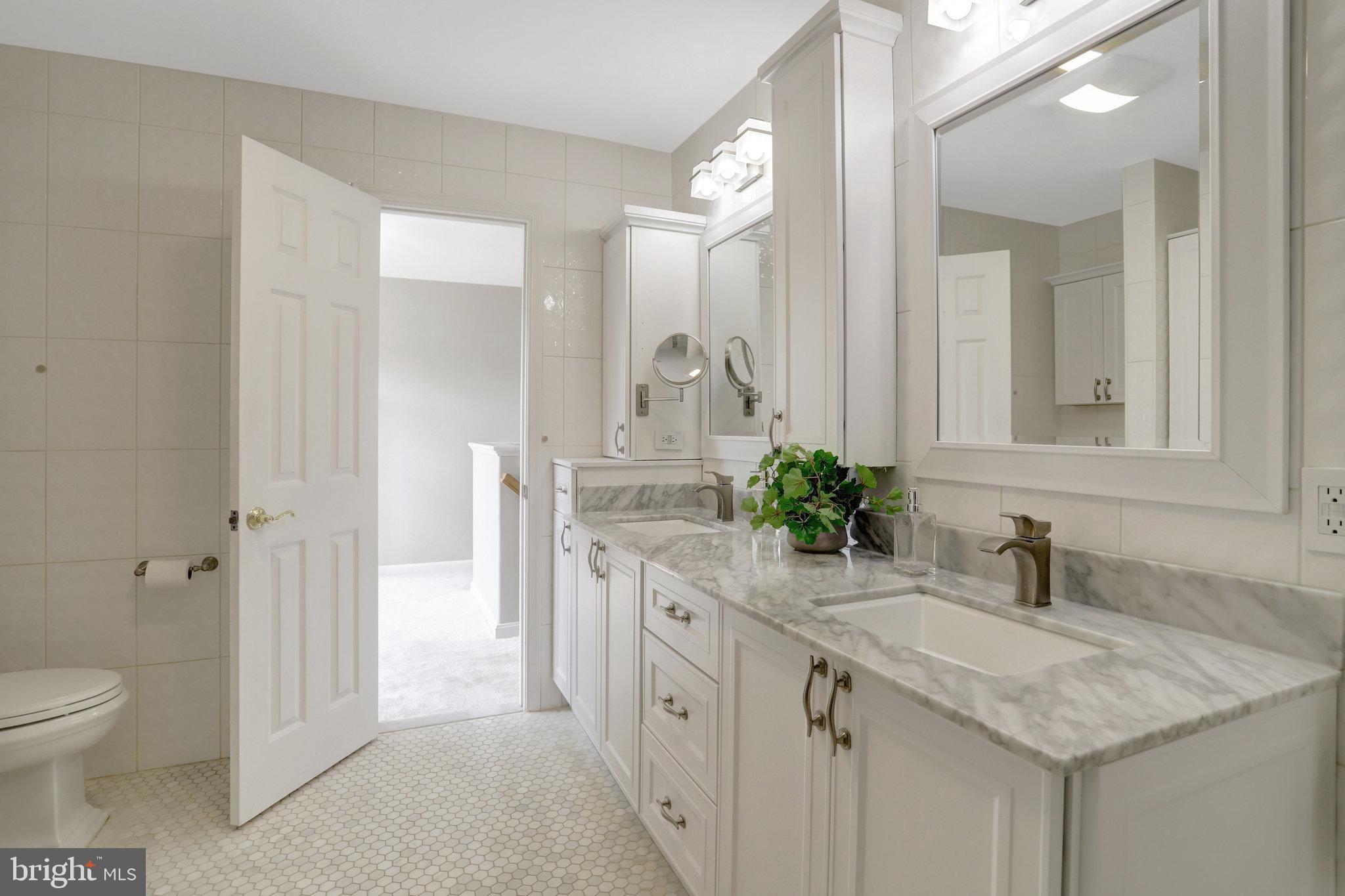8552 Bauer Circle Springfield, VA 22152 - Photo 36 of 64 a spacious bathroom with a granite countertop sink and a mirror