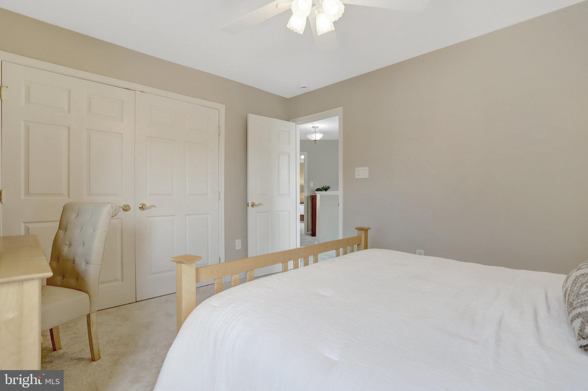 8552 Bauer Circle Springfield, VA 22152 - Photo 44 of 64 a bedroom with a bed and a chandelier