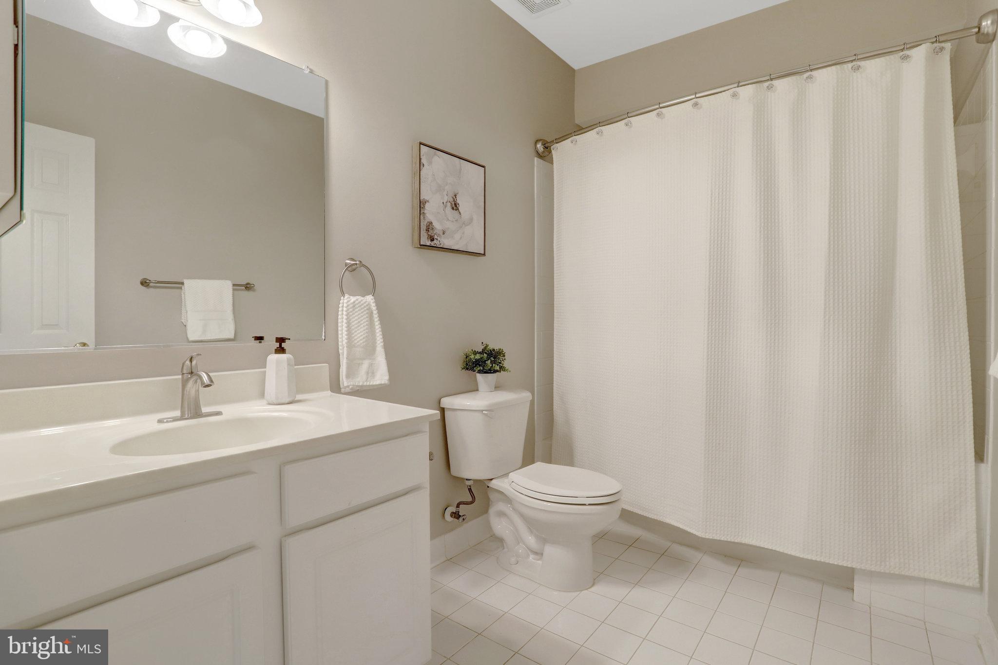 8552 Bauer Circle Springfield, VA 22152 - Photo 53 of 64 a bathroom with a sink a toilet and a mirror