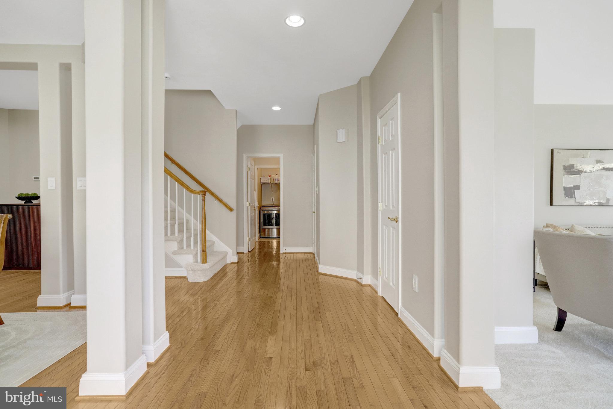 8552 Bauer Circle Springfield, VA 22152 - Photo 7 of 64 a view of a hallway with wooden floor and staircase
