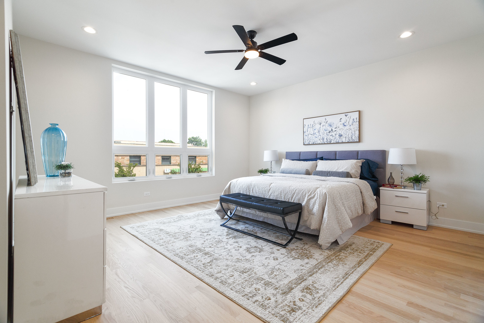 3502 North Central Avenue Chicago, IL 60634 - Photo 16 of 33 a bedroom with a large bed a large window and a potted plant
