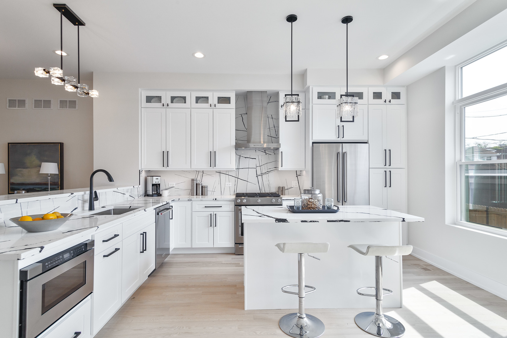 3502 North Central Avenue Chicago, IL 60634 - Photo 7 of 33 a kitchen with stainless steel appliances kitchen island granite countertop a sink a stove a dining table and chairs