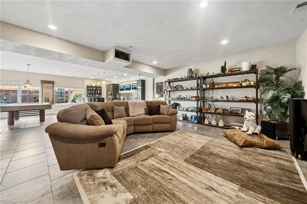 a living room with furniture a walk in closet and a large window