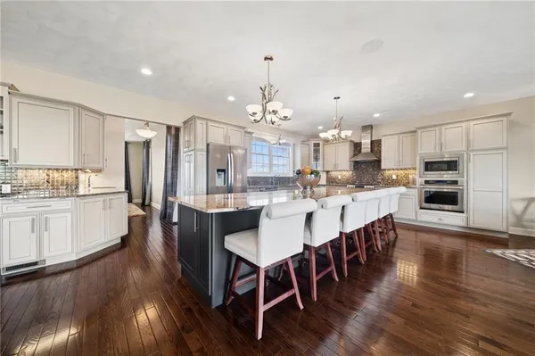 a large kitchen with a table and chairs