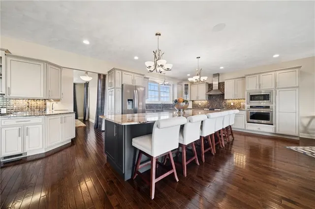 a large kitchen with a table and chairs