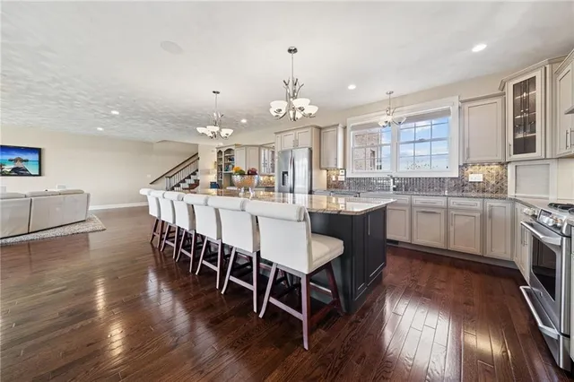 a large kitchen with a table and chairs