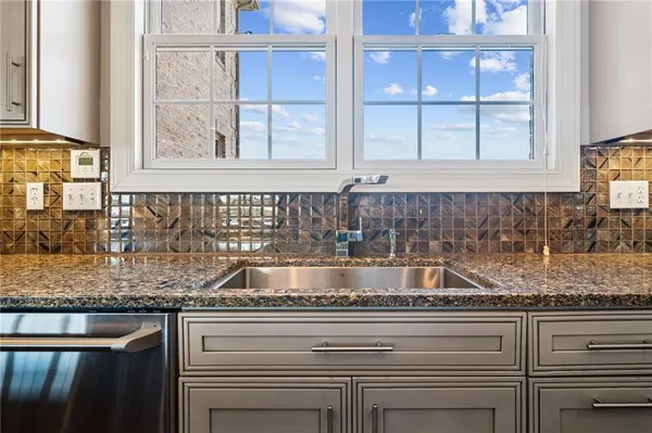 a kitchen with granite countertop a sink and a window