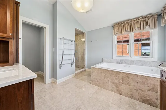 a spacious bathroom with a tub and a sink