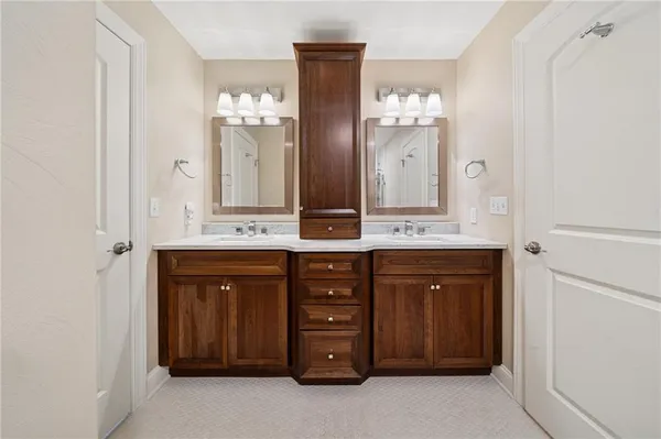 a bathroom with a double vanity sink and a mirror