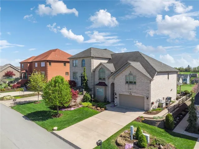 a front view of house with yard and green space
