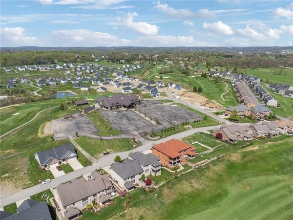 an aerial view of residential houses with outdoor space and river