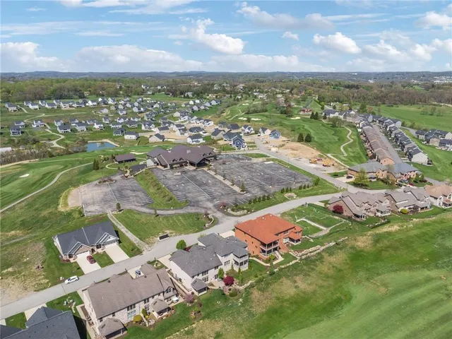 an aerial view of residential houses with outdoor space and river