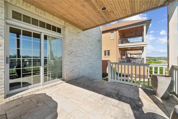 a view of a brick house with large windows